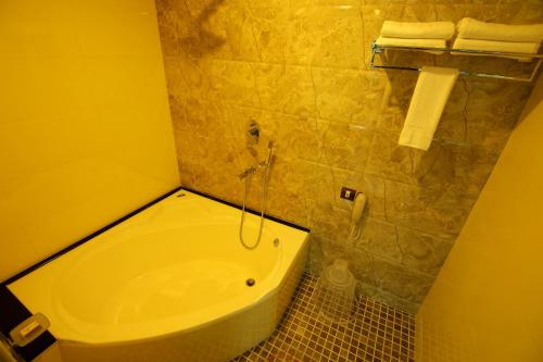 a bathroom with a toilet and a sink at Hotel Hillway Park in Kollam