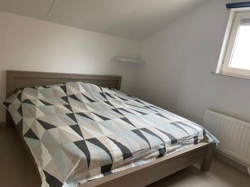 מיטה או מיטות בחדר ב-Westerhuisje