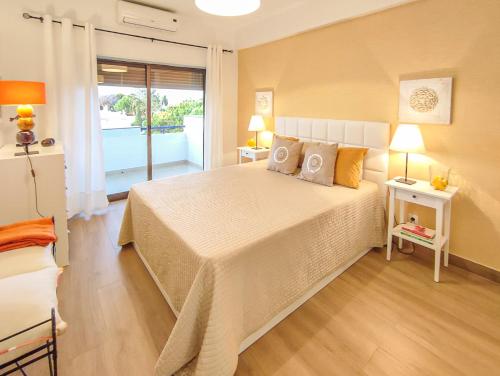 a bedroom with a large bed with two pillows at Apartamento Gomes -Free Airco, wiffi & Swimming Pool- by bedzy in Porches