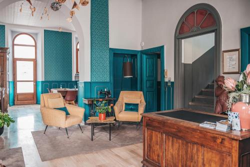 a living room with blue walls and a pool table at Hotel Casa Camilla in Verbania
