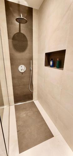 a bathroom with a shower with a shower head at Comfort Studio Bella Lucia in Portorož