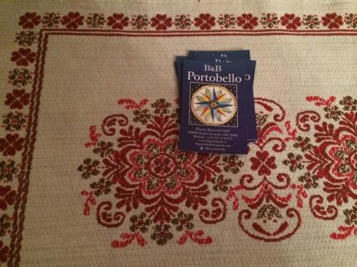 a book sitting on top of a red and white rug at B&B Portobello in Sestri Levante