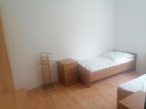 a bedroom with a bed and a night stand at Gästehaus an der Warnow in Schwaan