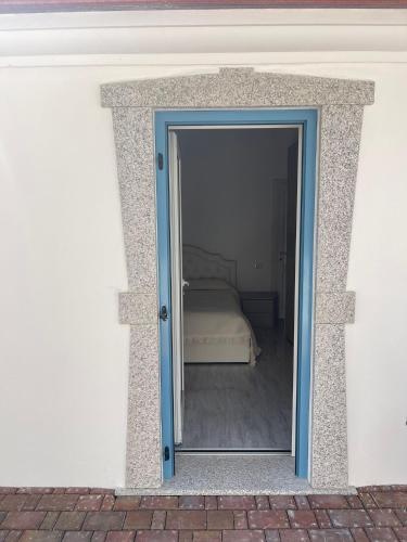 a glass door leading to a bedroom with a bed at La perla del mare in La Caletta