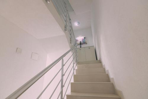 a staircase in a white room with white walls at VILLA EKATERINA in Ohrid