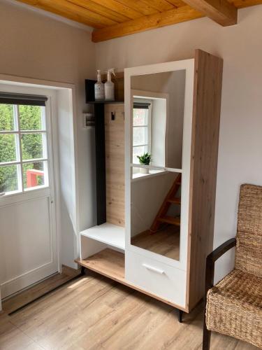 a dressing room with a mirror and a chair at Private apartments in Preila in Preila