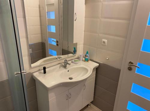 a bathroom with a sink and a mirror at Jurič in Rogoznica