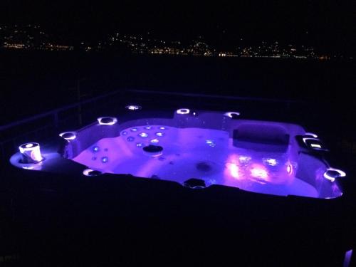 a hot tub lit up in purple at night at Residence Dorio in Dorio
