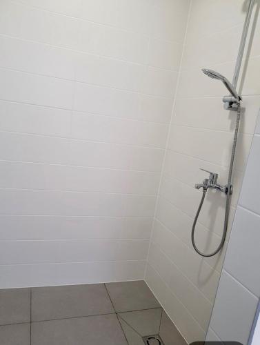 a shower stall with a shower head in a bathroom at Luxurious Four Bedroom Beach Penthouse in Podstrana