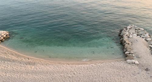 an aerial view of a beach with rocks and water at Luxurious Four Bedroom Beach Penthouse in Podstrana