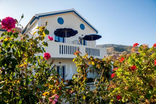 a white building with umbrellas on top of it at Dreams Apartments - Katelios,Santa Barbara beach in Katelios