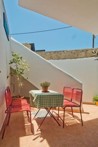 a table and two chairs and a table and a table and chairs at Aegean Sea in Lefkos Karpathou