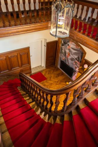 an overhead view of a staircase with a red carpet at Apartment in historischer Villa mit Parkplatz in Grünau im Almtal