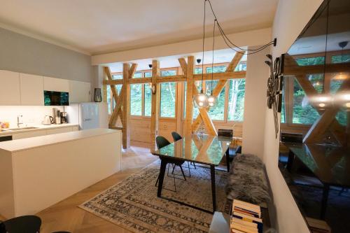 a kitchen and dining room with a table in a room at Apartment in historischer Villa mit Parkplatz in Grünau im Almtal