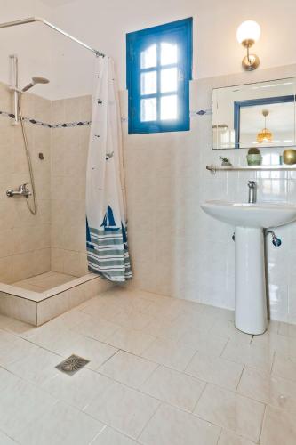a bathroom with a sink and a shower and a sink at Aegean Sea in Lefkos Karpathou
