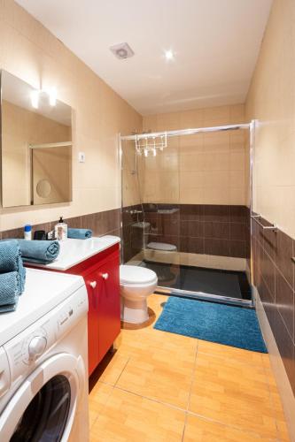 a bathroom with a shower and a toilet and a sink at El Chulo Apartamento in El Cotillo