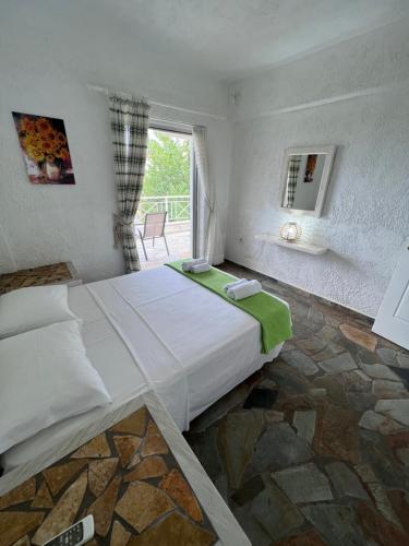 a bedroom with a large bed and a window at Phoenix Beachside Condos in Kokóni