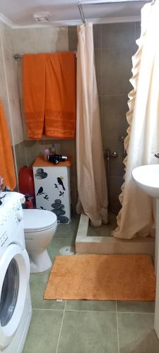 a bathroom with a toilet and a sink at Evi in Xylokastro