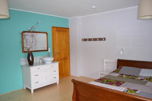 a bedroom with a bed and a mirror and a dresser at Mamut in Rozvadov