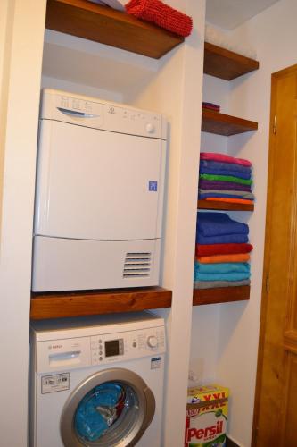 a laundry room with a washer and dryer at Mamut in Rozvadov