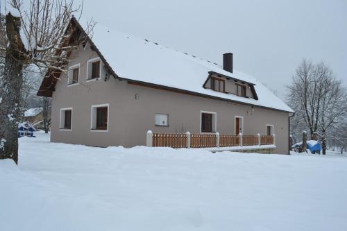 a white house with snow on the ground at Mamut in Rozvadov