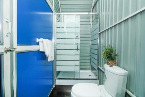 a bathroom with a toilet and a glass shower at A4 Residence Colombo Airport -by A4 Transit Hub - free pickup & drop Shuttle Serviceトランジットホテルトランジットホテル in Katunayaka