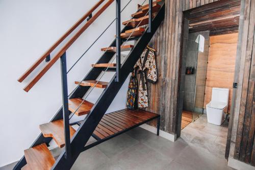a staircase in a room with a toilet at UMVA Muhazi - Adults Only in Muhazi