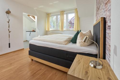 a bedroom with a large bed with a table in it at Thermen Appartements Gabriela, 38 qm in Bad Krozingen