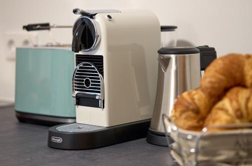 a toaster sitting on a counter next to a basket of bread at Thermen Appartements Gabriela, 38 qm in Bad Krozingen