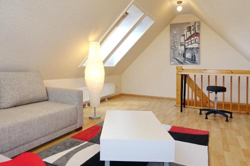 a living room with a couch and a table at Wiesengrund 9a Wohnung Bornholm in Wittenbeck