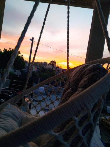 a hammock with a sunset in the background at Nikos' Home in Gastourion