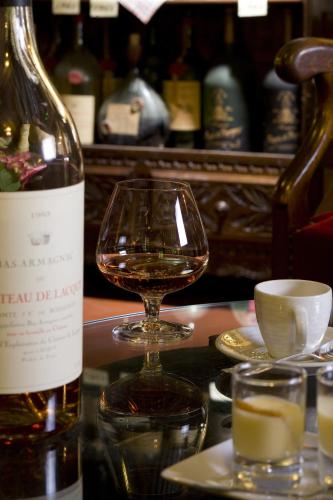 a bottle of wine and a glass on a table at Hotel Argi Eder in Aïnhoa