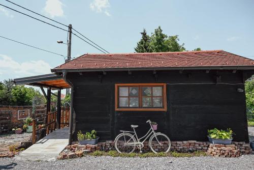 a bike parked outside of a black tiny house at Studio Apartment Romeo in Velika Gorica