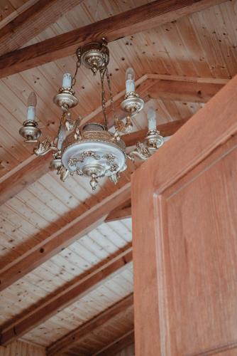 a chandelier is hanging from a wooden ceiling at Studio Apartment Romeo in Velika Gorica