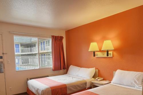 a hotel room with two beds and a window at Motel 6-Coeur D'Alene, ID in Coeur d'Alene