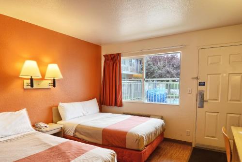 a hotel room with two beds and a window at Motel 6-Coeur D'Alene, ID in Coeur d'Alene