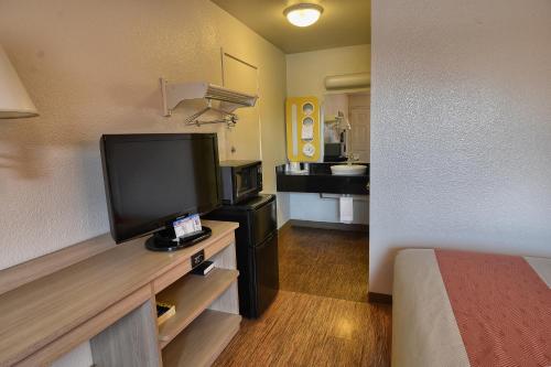 a room with a flat screen tv in a hotel room at Motel 6-Coeur D'Alene, ID in Coeur d'Alene