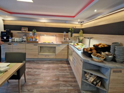 a large kitchen with a counter with food on it at Hotel Ocean in Norden