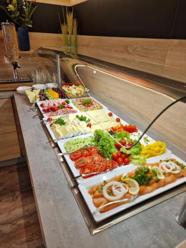 a buffet line with many different types of food at Hotel Ocean in Norden