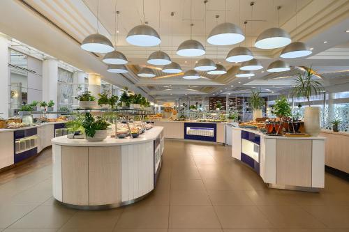 a large kitchen with island counters in a restaurant at Yam Suf by Isrotel Collection in Eilat