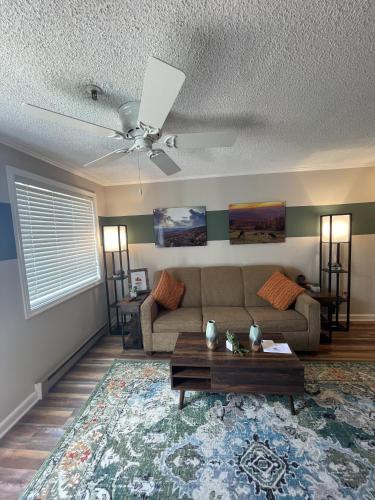 a living room with a couch and a table at Mountain Lodge getaway, ski-in/ski-out, heart of the village in Snowshoe