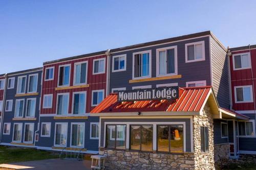 a large building with a sign for a mountain lodge at Mountain Lodge getaway, ski-in/ski-out, heart of the village in Snowshoe