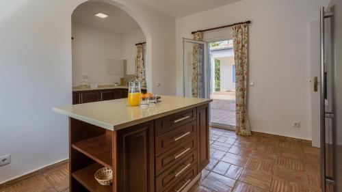 a kitchen with a counter with orange juice on it at Luxury Villa With Pool in Vineyard Near the Beach in Porches