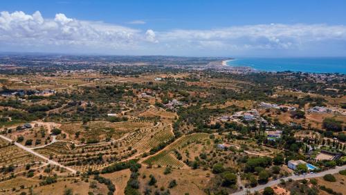 an aerial view of a town and the ocean at Quinta dos Capinhas in Porches