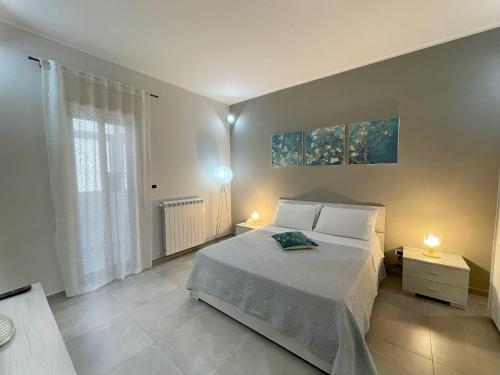 a bedroom with a bed with two lamps on it at Casa Lulu in Belpasso