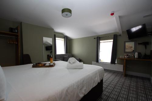 a bedroom with a large white bed in a room at Tyr Winch in Cardiff