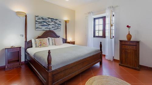 a bedroom with a large bed and a window at Cozy Algarve Home with Vineyard View Near Beaches in Porches