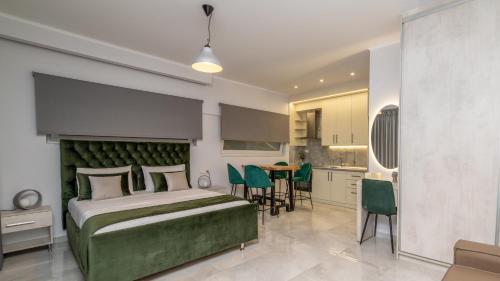 a bedroom with a bed and a table and a kitchen at Mansion House Parga in Parga