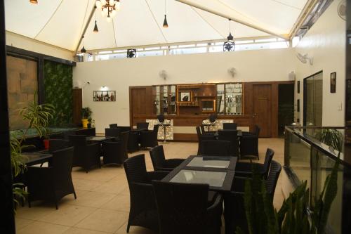 a restaurant with tables and chairs in a room at RIVERSIDE MEADOWS in Vidisha
