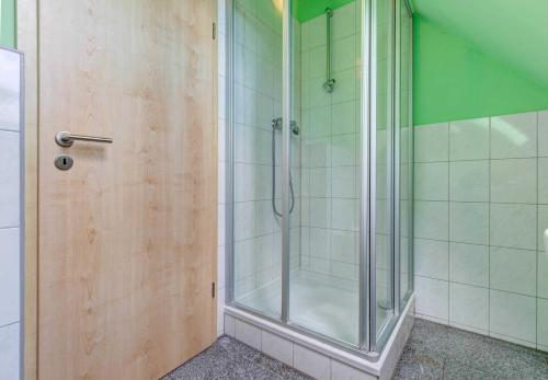 a shower with a glass door in a bathroom at Ferienwohnungen am Peenehafen Karl in Ostseebad Karlshagen